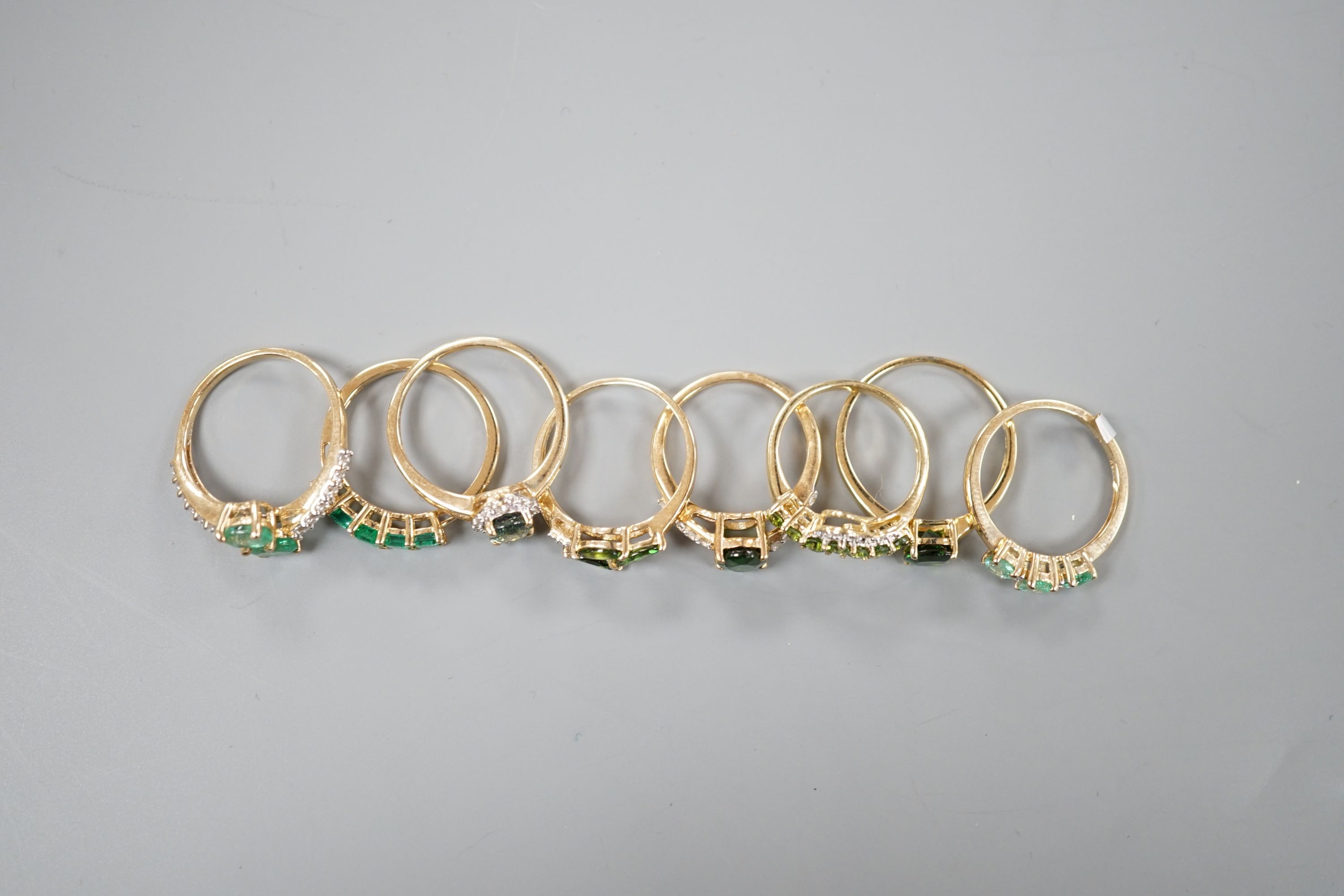 Eight assorted modern 9ct gold and gem set dress rings, including garnet, gross weight 16.8 grams.